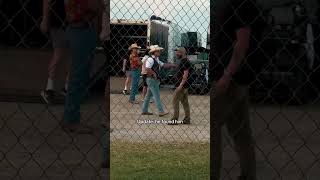 Gavin Adcock hides behind security after Zach Bryan confronts him at the Born and Raised festival.