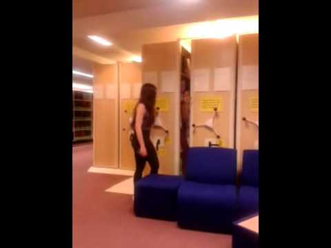 Girl Trapped Between bookshelves