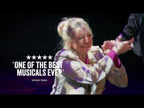 Blood Brothers musical UK tour trailer still with ensemble on stage and title card