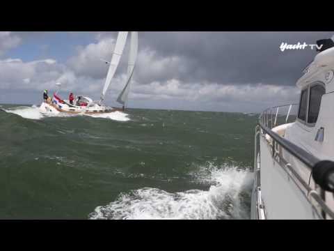 Rough weather: Motorboat versus sailing yacht in storm