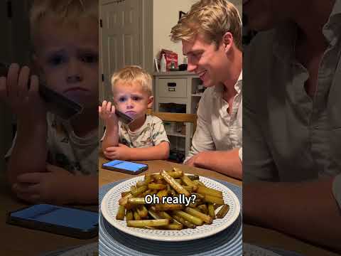 Every facial muscle is resisting. Baby is struggling but at least he has a phone!