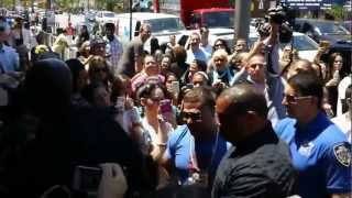 GIRL GRABS RONNIE AT SHORE STORE GRAND OPENING