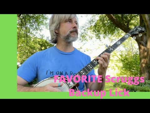 guy in blue shirt playing a banjo