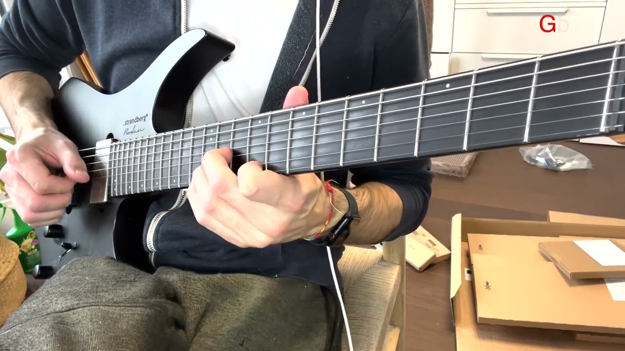 Guitarist playing a major triad on the top three strings of the fretboard
