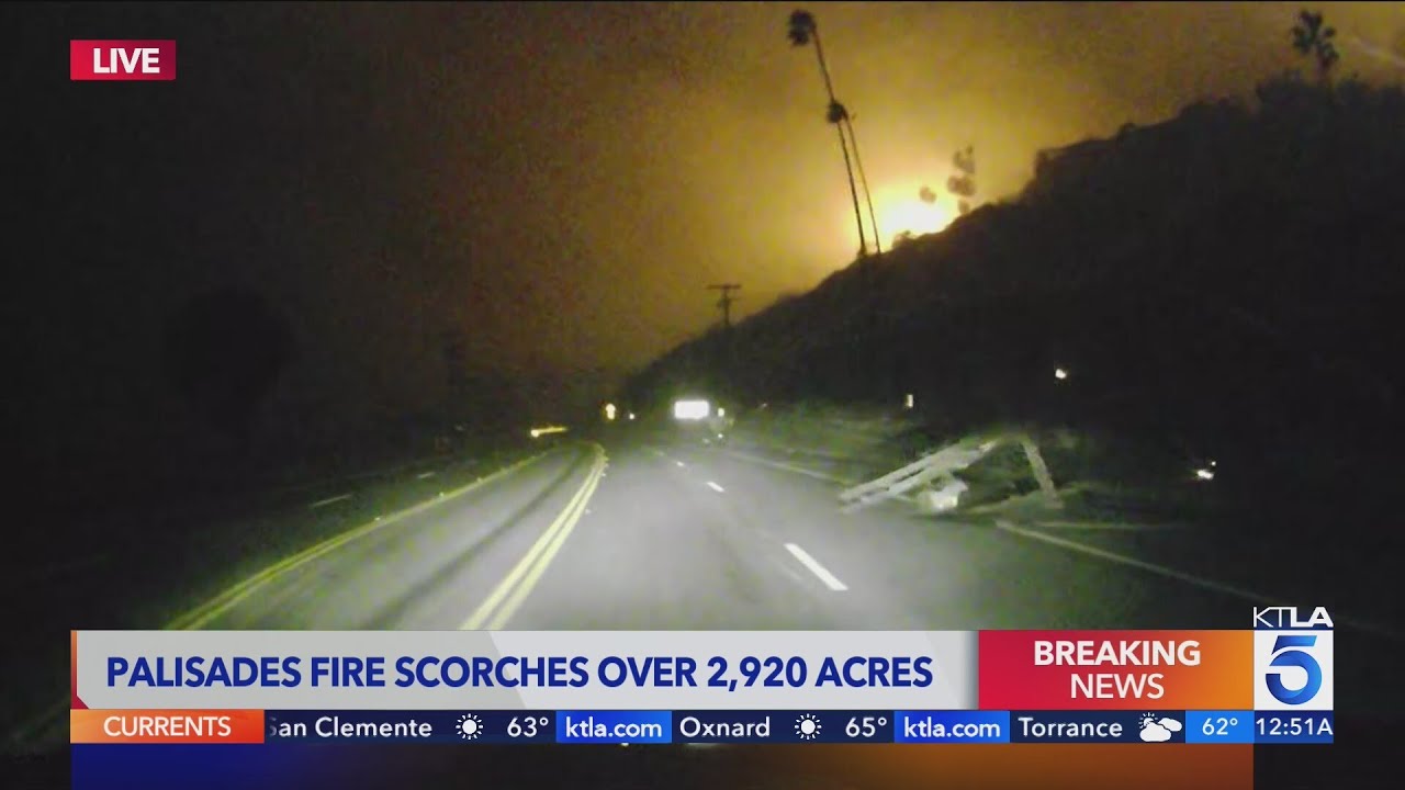 Palisades Fire: Utility pole, debris and flames seen from the Pacific Coast Highway