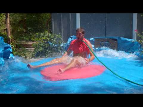 6ft Man in 6ft Giant Popping Water Balloon in Slow mo
