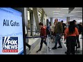 TSA TURMOIL Travelers Navigate Long Airport Security Lines Amid DHS Shutdown
