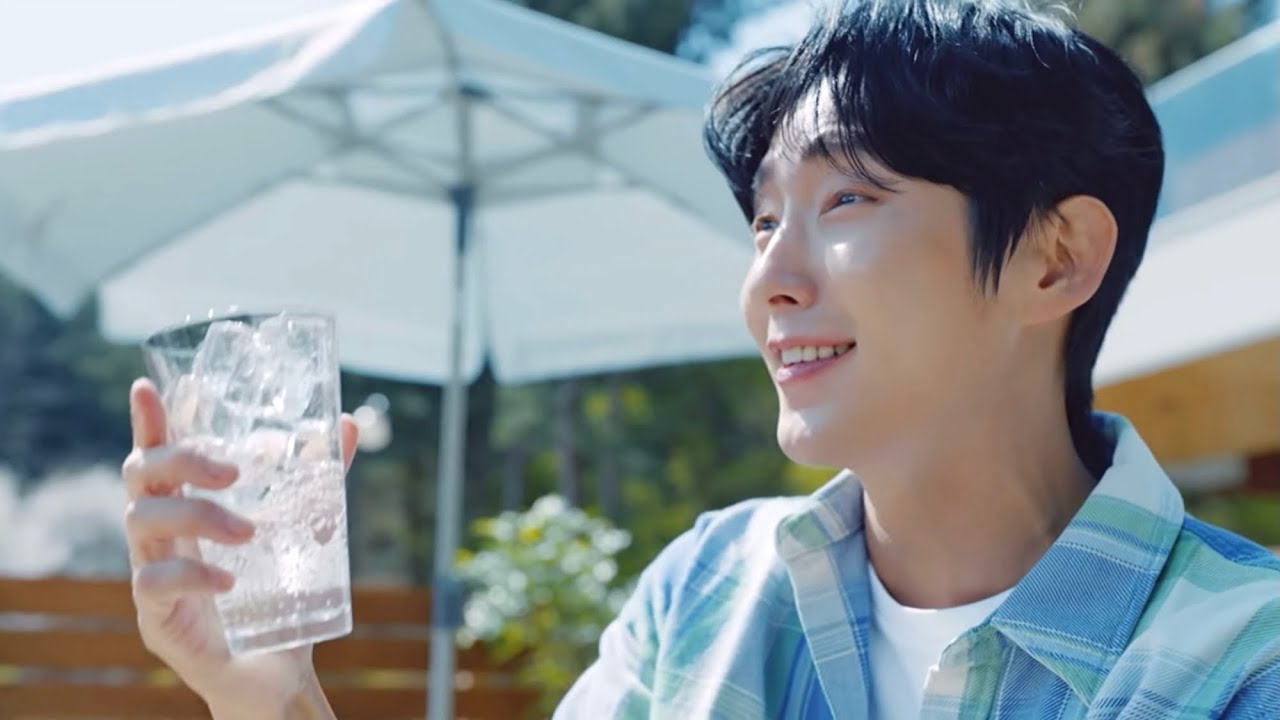 Park Min Young and Lee Joon-gi posing with bottles of Lotte Chilsung Cider in a Korean television commercial campaign shot