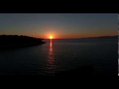 aerial footage of a sunset at a beach in time lapse