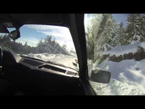 BMW snow climbing and drift on a narrow mountain road