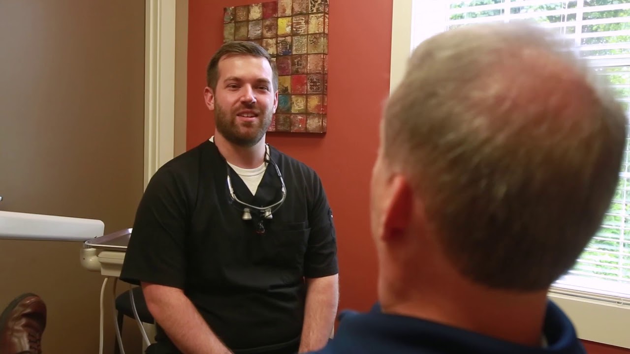 Prestonsburg dentist talking to a patient in dental chair
