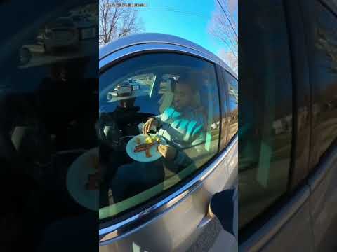 Driver Eating Full Breakfast During Traffic Stop
