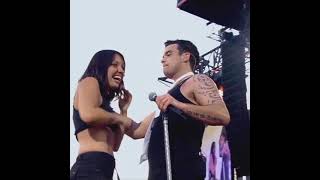 Robbie Williams taking a fangirl on stage during the performance of Come Undone, Knebworth, 2003.