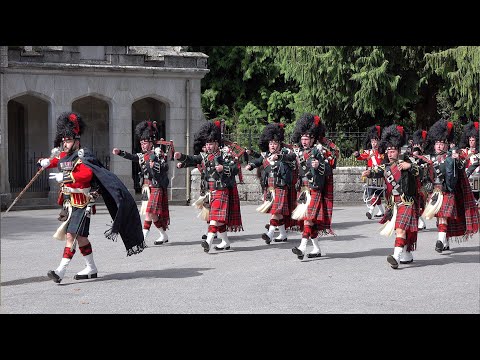 Black Watch Pipes and Drums lead the Royal Guard out of Balmoral Castle with pony mascot Cruachan IV