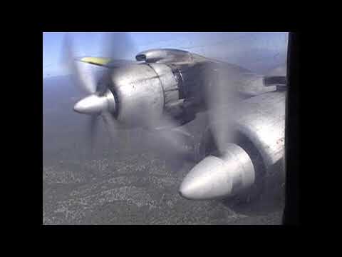 Douglas DC-7 Air Tanker during 2005's fire season,  is seen making a retardant drop.