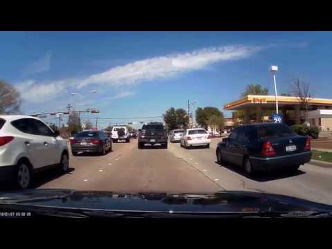 man crossing between cars on Coit and Parker road