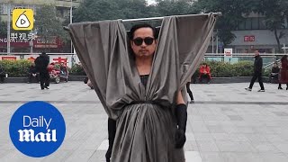 Chinese man makes bizarre costumes out of hangers and curtains