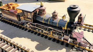 Charming Steam Locomotive Model Train Roams Backyard Rails with Realistic Sounds