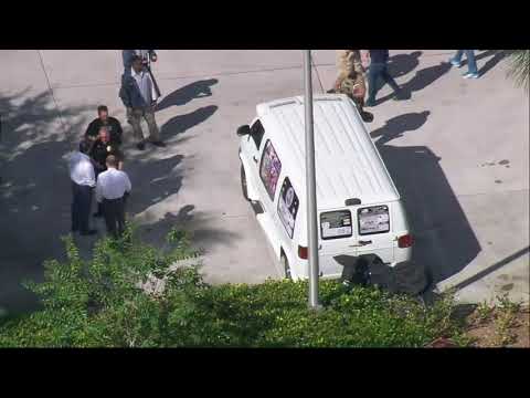 Federal officials were seen on television examining a white van, its windows covered with an assortment of stickers, in the city of Plantation and covering the vehicle with a blue tarp. (Oct. 26)