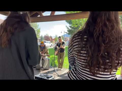 A raw frame from the livestream: people standing at an outdoor service