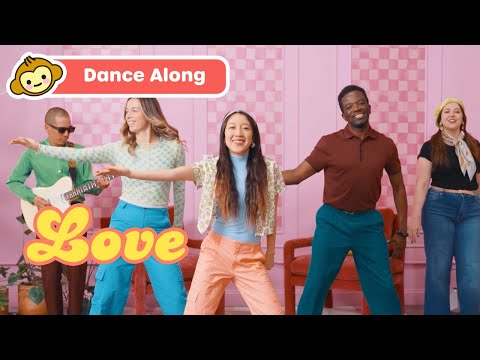 Five diverse people dancing in a pink room; banner reads 'Dance Along' and a yellow 'Love' graphic on the screen.