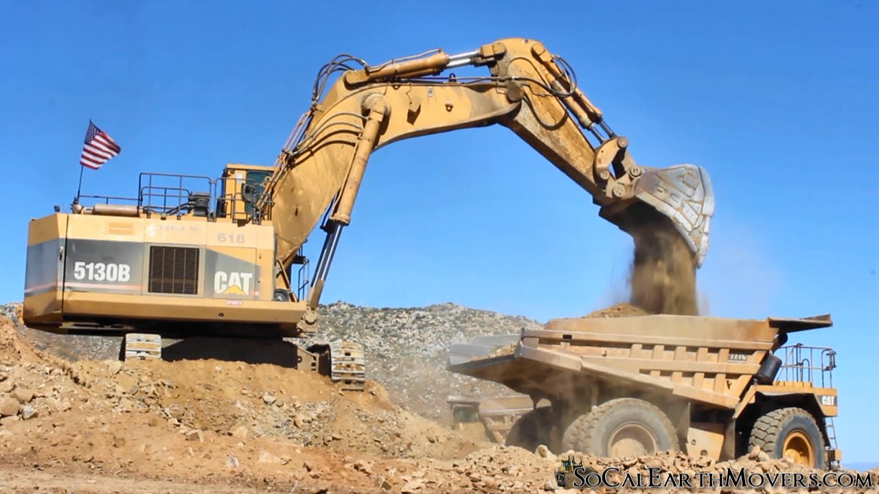 A CAT 5130B and 5130 loading 777 Haul Trucks on housing development