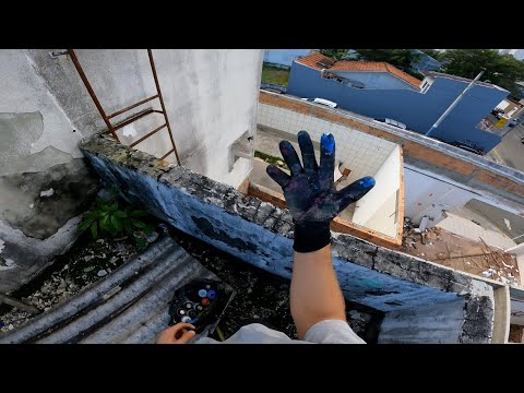 Climbing A Water-tank To Paint Graffiti During The Day