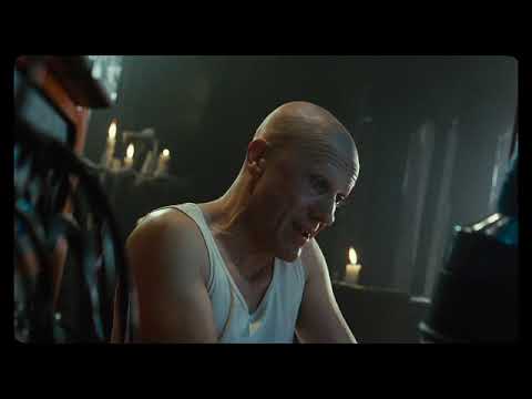 The Zero Theorem trailer frame of Qohen at his console, cables glowing green