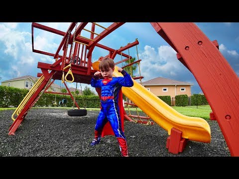 MARCOS PRETENDS TO BE SUPERMAN IN THE OUTDOOR PLAYGROUND FOR KIDS