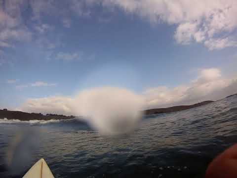 Surfing some waist high waves in front of the campground cliffs. Sorry for the large water droplet on the lens. 