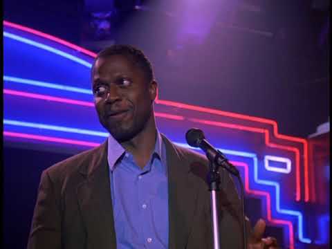 Trailer frame: microphone in spotlight; the sound palette toggles between bar-band grit and soft-focus balladry