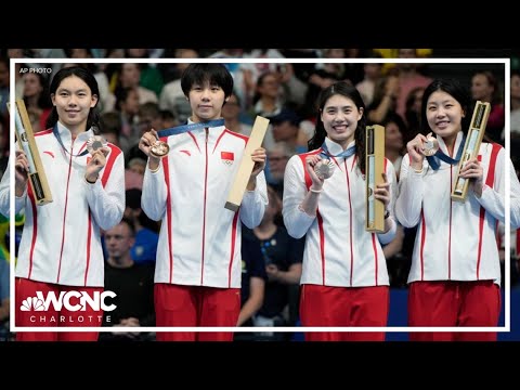 Part of a video titled Here's what's in the box Olympians get on the podium - YouTube