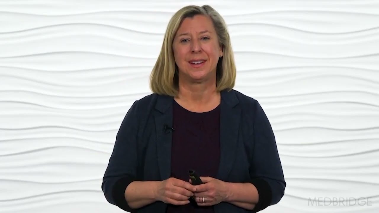 A woman smiling while holding a small object, representing Medbridge's impact on digital healthcare.