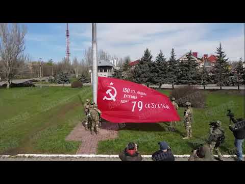 True Face of Putins Soviet Modor: Russian Soldiers hoist the Soviet Victory Banner in Kherson