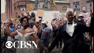 Couple takes powerful wedding photos among protesters in Philadelphia