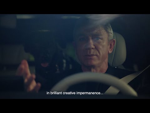 Still from the BYD DENZA brand film featuring Daniel Craig with cinematic landscape backdrop