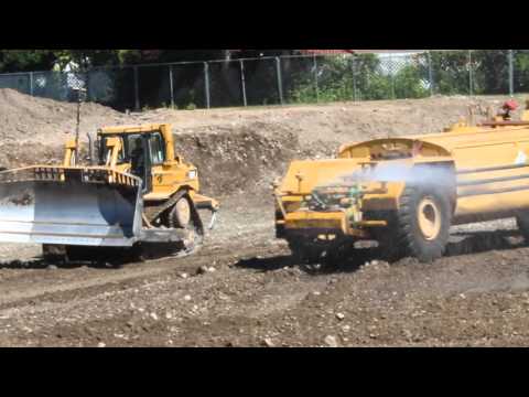 CAT D8T Bulldozer moving dirt around the foundation of a school construction site