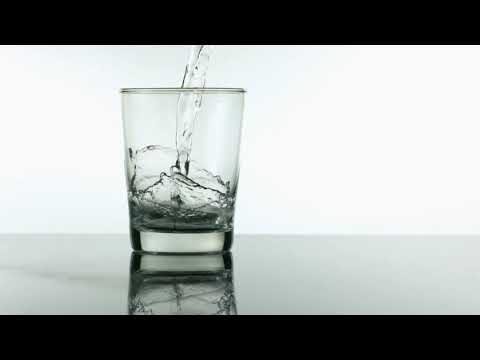 FREEDIO: "Water pouring into glass slow motion" royalty free HD stock video footage