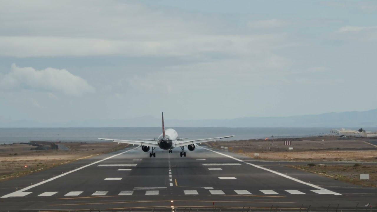 A Frontal Shot Of An Airport Runway With A Landing Aircraft From The Back 4k | By Creator Stockify
