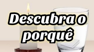 Copo com água ao lado da vela do anjo da guarda