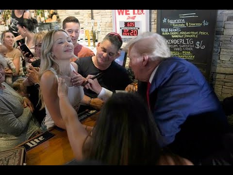 CAUGHT ON CAMERA Trump signs woman's tank top