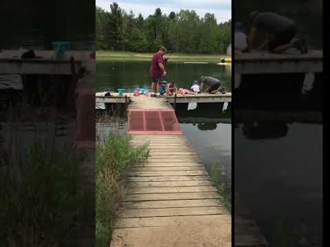 Catching fish on the doc with nets and poles.