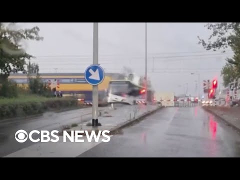 Train slams bus sitting on Dutch railroad crossing