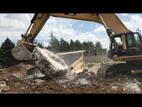 Caterpillar 385C Excavator With Help Of Caterpillar D9T Bulldozer Loading Huge Blocks On Dumpers