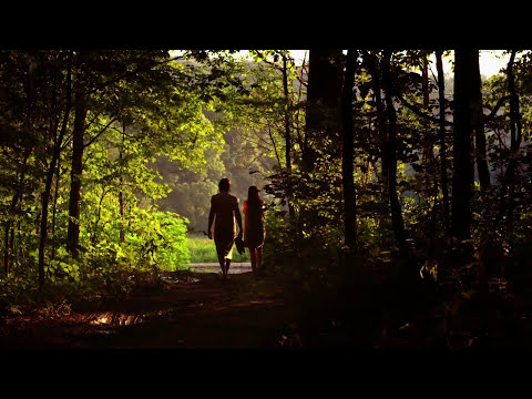 Montage of walks, drives, and coffeehouse talks set to roots and world-music cues