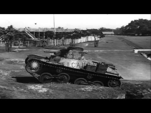 A captured 1941 model Japanese light tank being tested by Allies at an encampment...HD Stock Footage