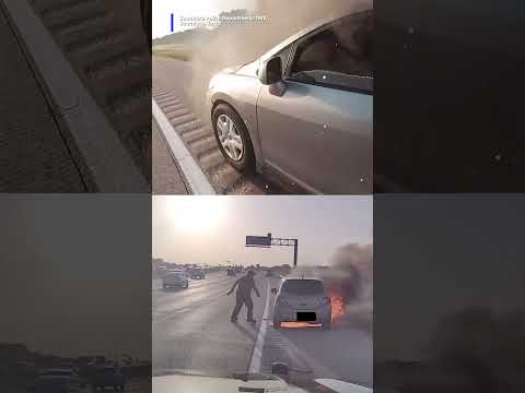 Police officer quickly jump into action to rescue a driver from a burning car