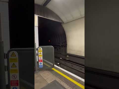 EXTREME SPEED, London underground train approaches platform at high speed.