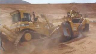 CAT D9R ripping & push loading a 651B