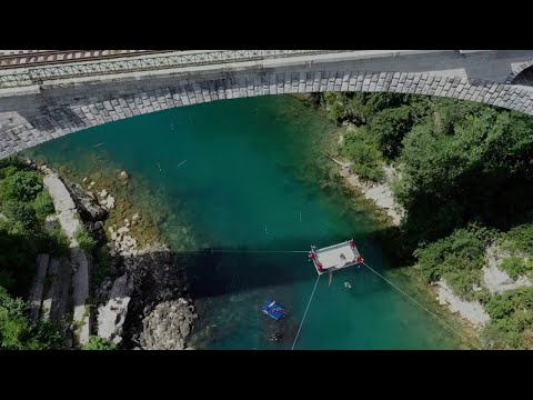 Daredevils Perform Flips From Trampoline Hanging From Bridge
